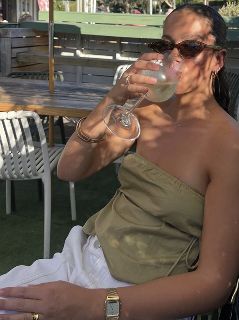 A customer enjoying a glass of wine at Hey Darl